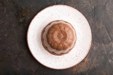 Chocolate jelly on black concrete background. top view, flat lay