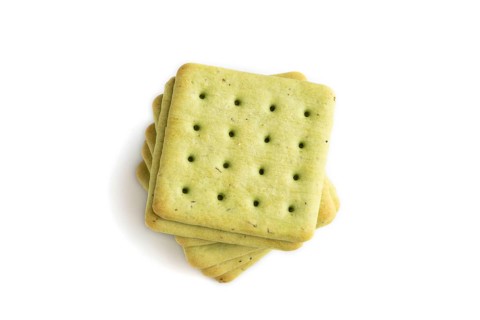 Green cracker pile isolated on white background. top view, flat lay, close up