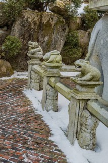 Stone carved dragon, rabbit and bear that represents the Chinese horoscope, on concrete fence in