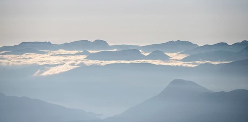 High fog between mountain peaks, view from the summit of Skala, Loen, Norway, Europe
