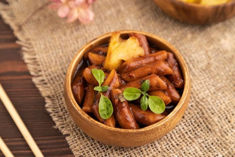 Tteokbokki or Topokki, fried rice cake stick, popular Korean street food with spicy jjajang sauce