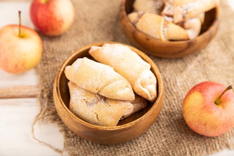 Homemade sweet cookie with apple jam and cup of coffee on white wooden background and linen textile