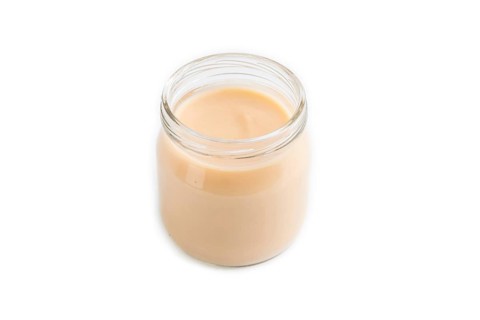 Baby puree with fruits mix, apple, banana infant formula in glass jar isolated on white background.