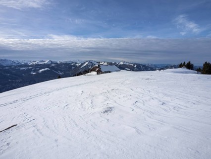 Winter atmosphere, snow-covered landscape, snow-covered alpine peaks, alpine hut on the