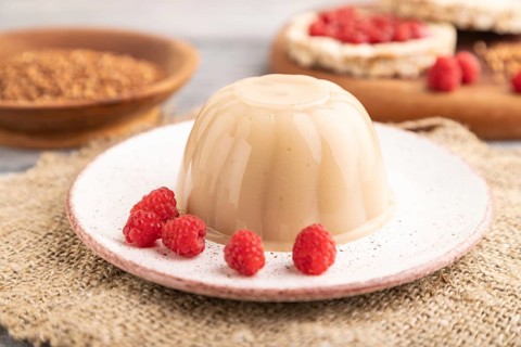 Buckwheat milk jelly on gray wooden background and linen textile. side view, close up, selective