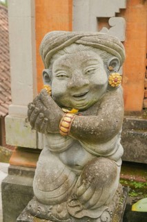 Balinese stone statue in Ubud, Bali, Indonesia. Travel, spirituality, religion