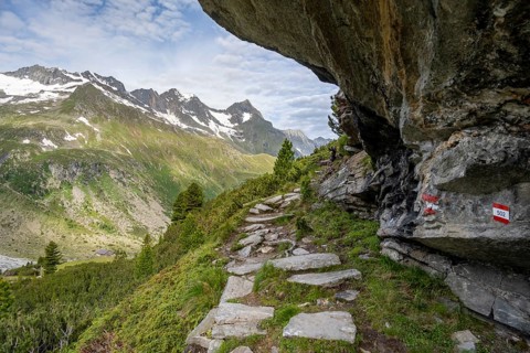 Hiking trail under a rocky outcrop in a picturesque mountain landscape, Berliner Hoehenweg,