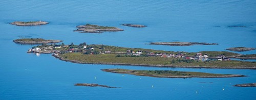 Rocky islands with colourful houses, sea with archipelago islands, Ulvagsundet, Vesteralen, Norway,