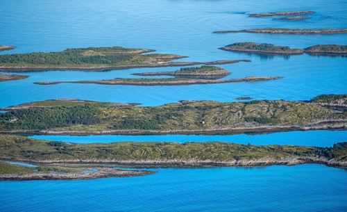 Rocky islands in the blue sea, sea with archipelago islands, Ulvagsundet, Vesteralen, Norway,