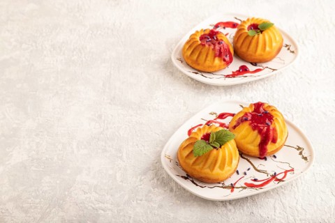 Semolina cheesecake with strawberry jam, lavender on gray concrete background. side view, copy