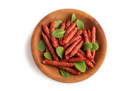 Small smoked sausage with borage microgreen isolated on white background. Top view, flat lay, close