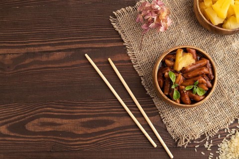 Tteokbokki or Topokki, fried rice cake stick, popular Korean street food with spicy jjajang sauce