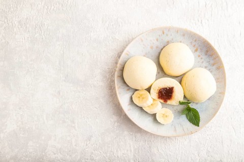Japanese rice sweet buns mochi filled with jam on a gray concrete background. top view, flat lay,