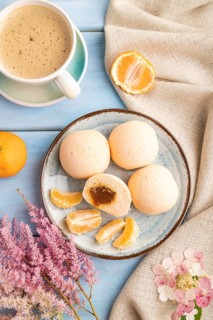 Japanese rice sweet buns mochi filled with tangerine jam and cup of coffee on a blue wooden