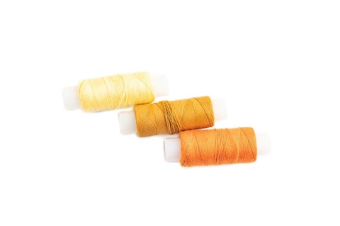 Spool of thread isolated on white background. Top view, flat lay, close up