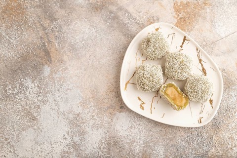 Japanese rice sweet buns mochi filled with pandan jam on brown concrete background. top view, flat