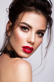 Gorgeous Young Brunette Woman face portrait. Beauty Model Girl with bright eyebrows, perfect