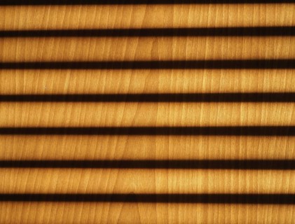Blinds shadow on wooden wall background