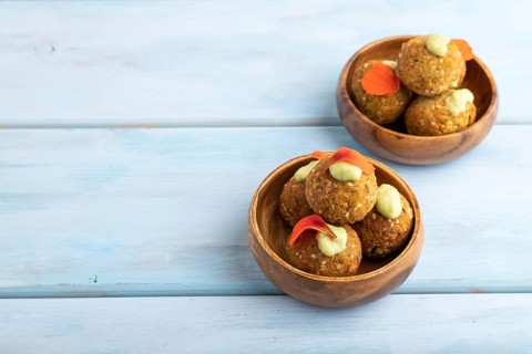 Falafel with guacamole on blue wooden background. Side view, copy space