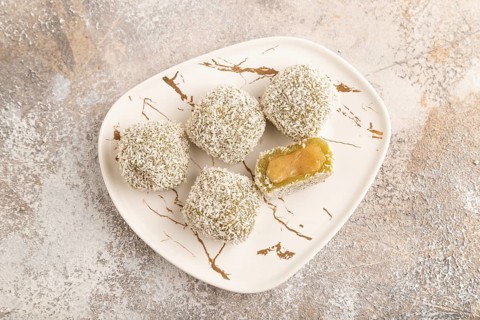 Japanese rice sweet buns mochi filled with pandan jam on brown concrete background. top view, flat