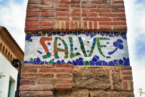 Greeting salute at Casa Trias, tiles with inscription, mosaic, Trencadis, Park Gueell, Barcelona,