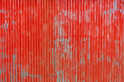 Red painted corrugated iron wall, abandoned herring factory Djupavik, Reykjarfjoerour, Strandir,