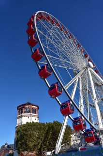 View over the Rhine terrace of Duesseldorf with the castle tower and the Ferris wheel of the