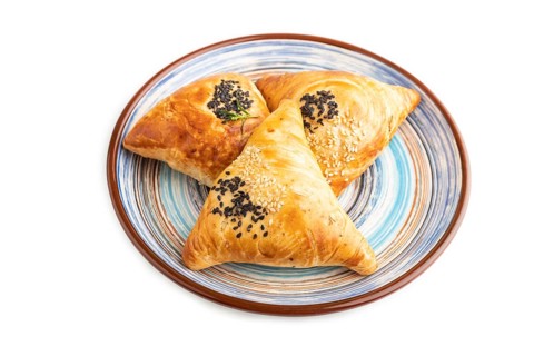 Homemade asian pastry samosa isolated on white background. side view, close up