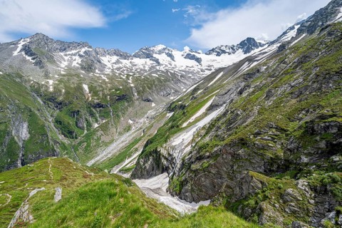 Picturesque mountain landscape with rocky mountains and glaciers, behind mountain peak Grosser