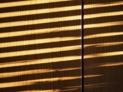 Blinds shadow on wooden wall background
