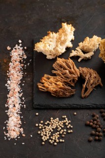 Raw Sparassis (Cauliflower Mushroom), Hericium, Clavaria (coral mushroom) on black concrete