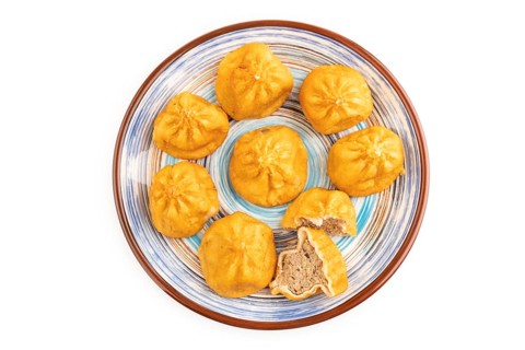 Fried manti dumplings isolated on white background. Top view, flat lay, close up