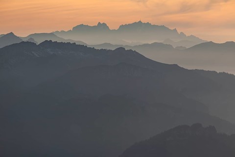 Silhouette of a mountain peak in the evening light, haze, backlight, autumn, view from the