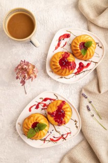 Semolina cheesecake with strawberry jam, lavender, cup of coffee on gray concrete background and