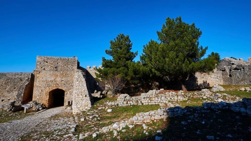 Ruins of an old fortress with a prominent pine tree, Chlemoutsi, High Medieval Crusader castle,