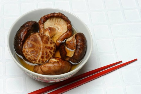 Dried shiitake mushrooms in a bowl, soaked in water