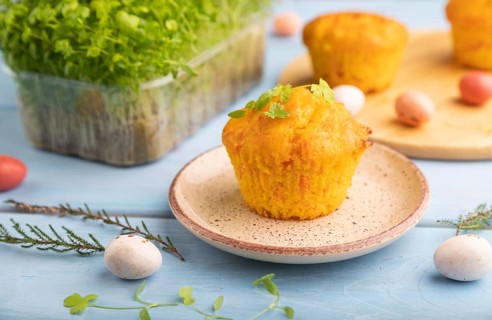 Homemade cakes with chocolate eggs and spinach microgreen on a blue wooden background. side view,