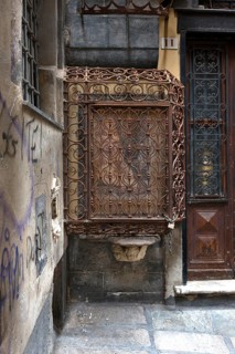 18th century Madonna and Child, protected by a wrought iron grille, in the historic centre, Al civ.
