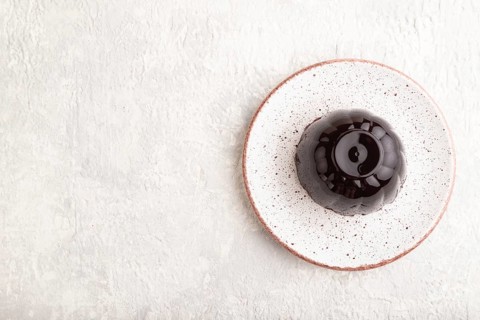 Black currant and grapes jelly on gray concrete background. top view, flat lay, copy space