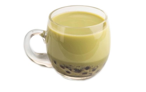 Bubble tea with pistachio and caramel in glass isolated on white background. Healthy drink concept.