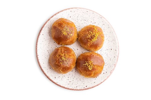 Homemade traditional turkish dessert sekerpare with almonds and honey isolated on white background.