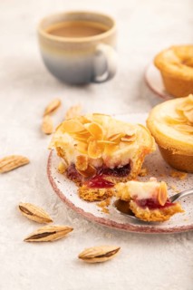 Traditional portuguese cakes pasteis de nata, custard small pies with almonds with cup of coffee on