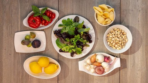 Food photography Lettuce, tomatoes, lemon, garlic, pistachios, figs, onion, pearl onion, shell