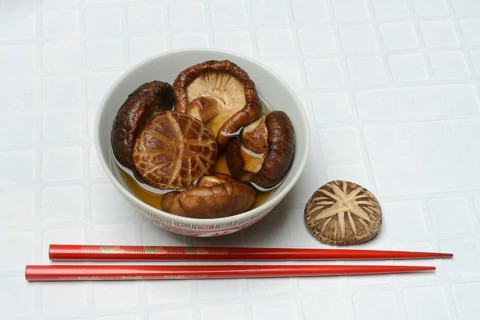 Dried shiitake mushrooms in a bowl, soaked in water