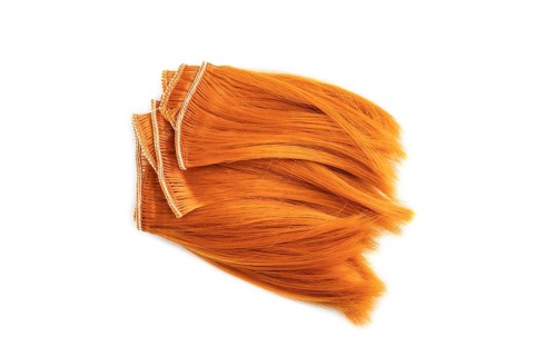 Orange braid isolated on white background. Top view, flat lay, close up
