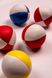Five juggling balls on a white background, selective focus, studio shot, Germany, Europe