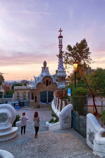View from the dragon staircase of buildings with colourful mosaics, Park Güell entrance, dawn,
