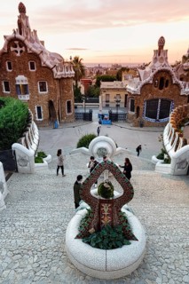 View from the dragon staircase of buildings with colourful mosaics, Park Güell entrance, dawn,