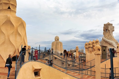 Tourists between artistically designed fireplaces on the large viewing platform, roof terrace in