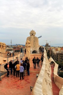 Tourists between artistically designed fireplaces on the large viewing platform, roof terrace in